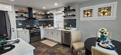 a kitchen with a sink cabinets and appliances