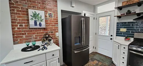 a kitchen with stainless steel appliances a refrigerator and a stove
