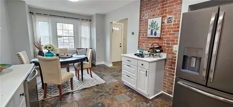 a view of a dining room with furniture window and outside view