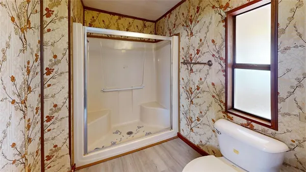 a bathroom with a toilet and shower