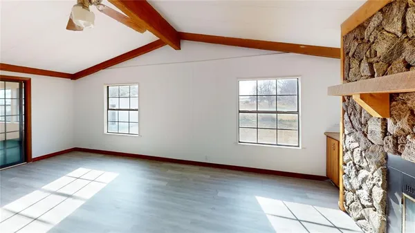 a view of an empty room with windows