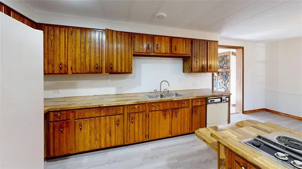 a kitchen with wooden cabinets and a sink