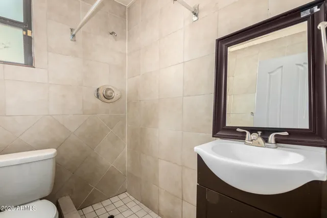 a bathroom with a sink toilet a mirror and shower