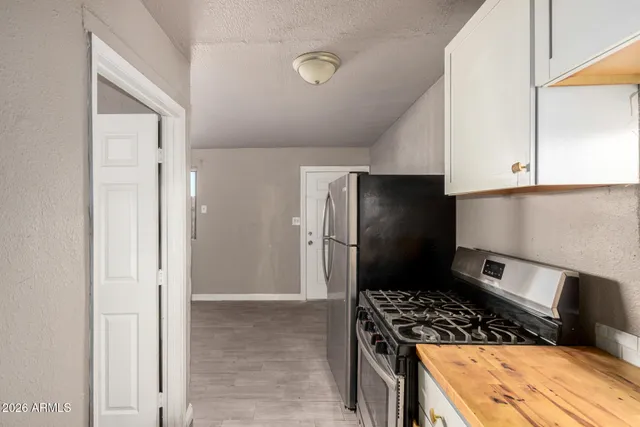 a kitchen with a refrigerator and a stove
