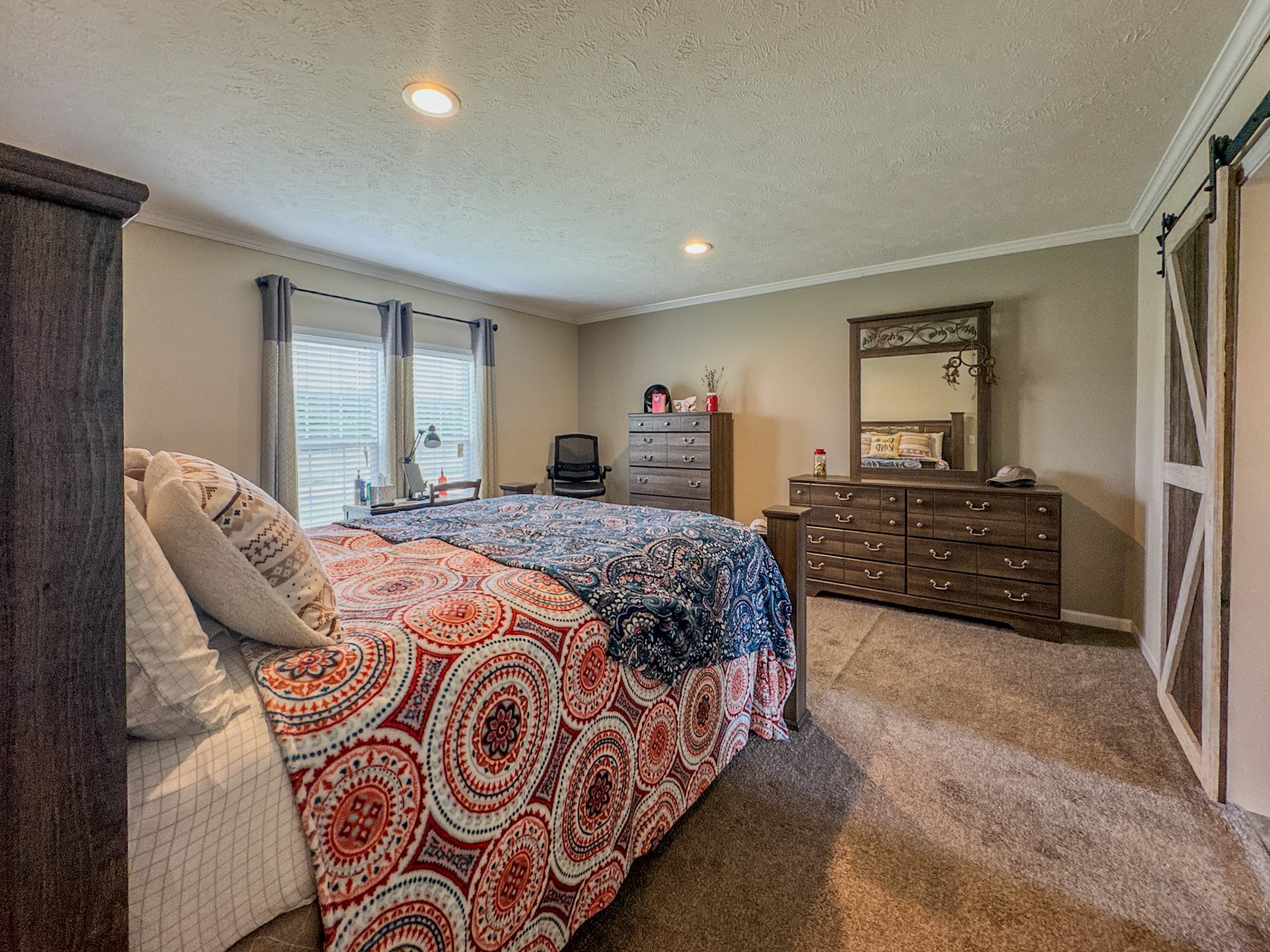 1198 David Patterson Road Lutts, TN 38471 - Photo 27 of 82 a bedroom with a bed and dresser with mirror