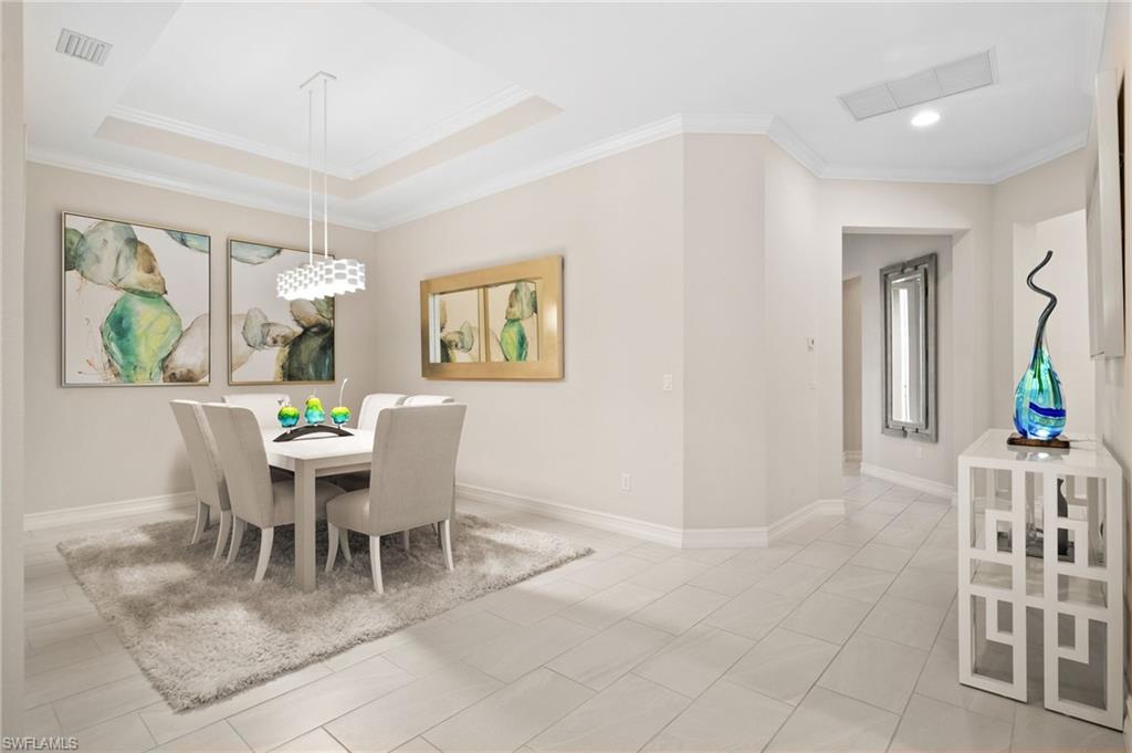 6608 Roma Way Naples, FL 34113 - Photo 12 of 50 Tiled dining space featuring crown molding and a raised ceiling
