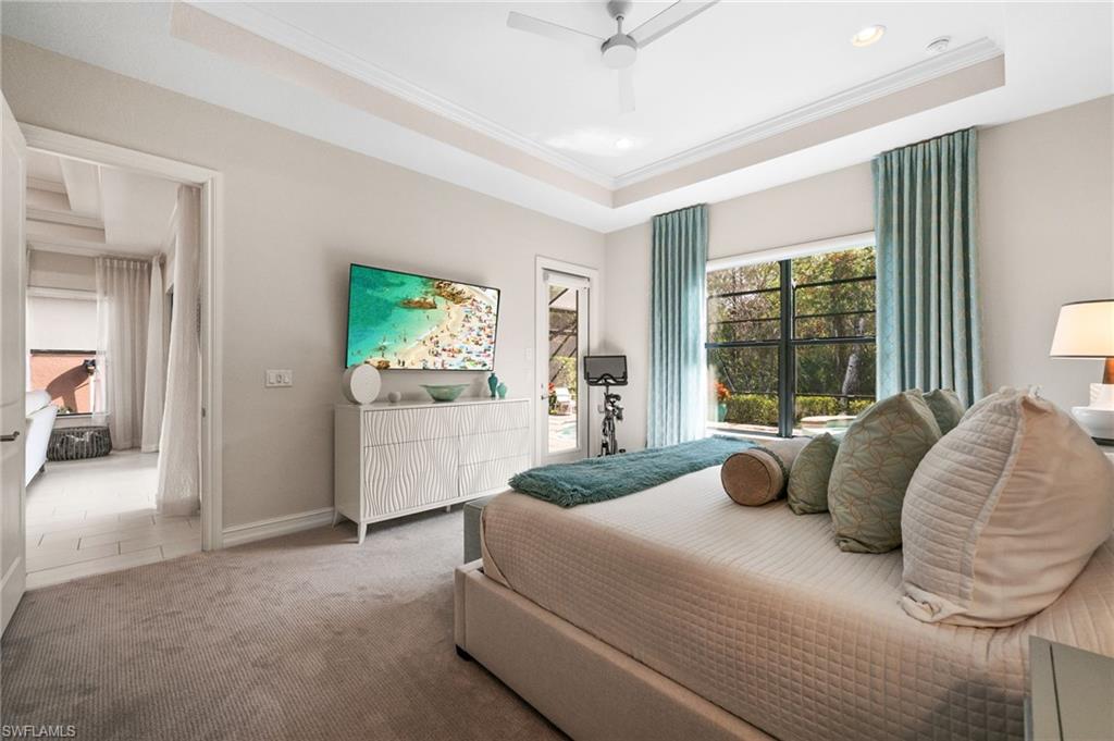 6608 Roma Way Naples, FL 34113 - Photo 15 of 50 Carpeted bedroom with ceiling fan, a tray ceiling, and ornamental molding