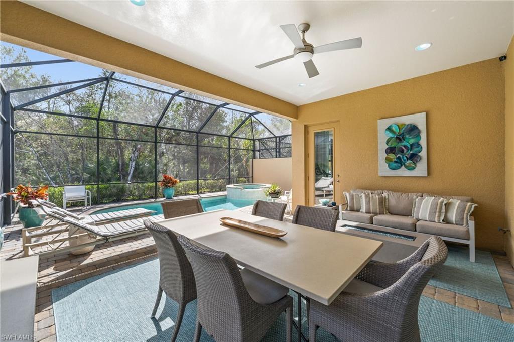 6608 Roma Way Naples, FL 34113 - Photo 20 of 50 View of patio / terrace with an outdoor hangout area, a swimming pool with hot tub, and glass enclosure