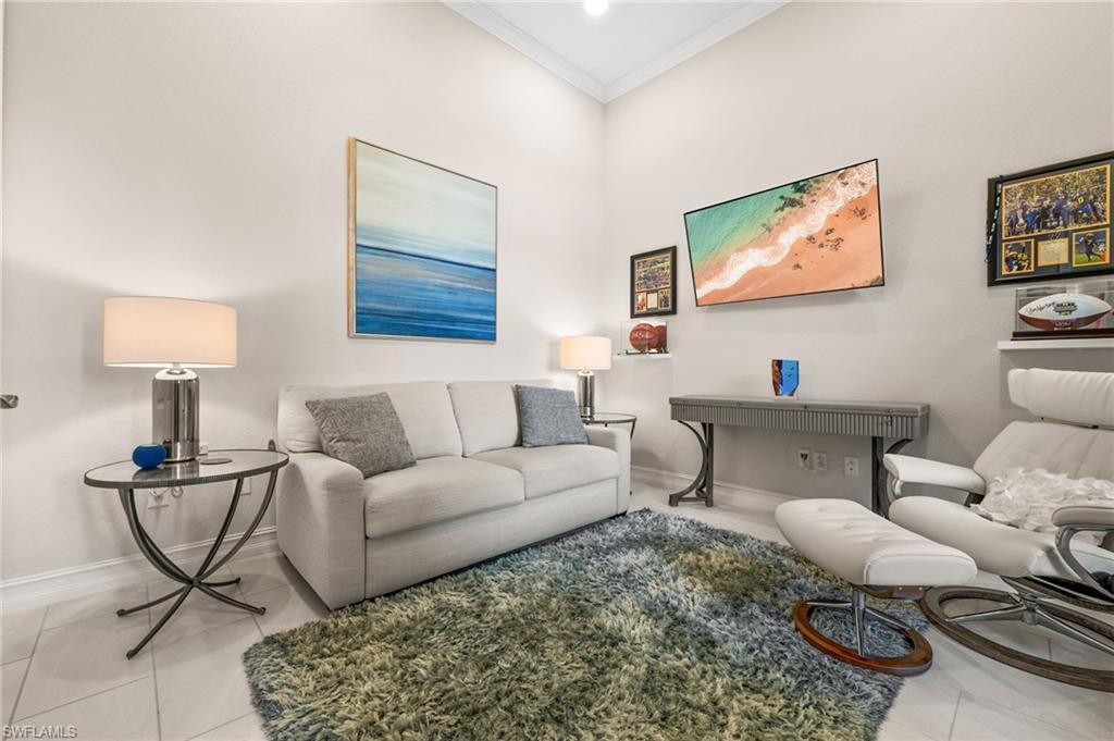 6608 Roma Way Naples, FL 34113 - Photo 21 of 50 Tiled living room featuring crown molding