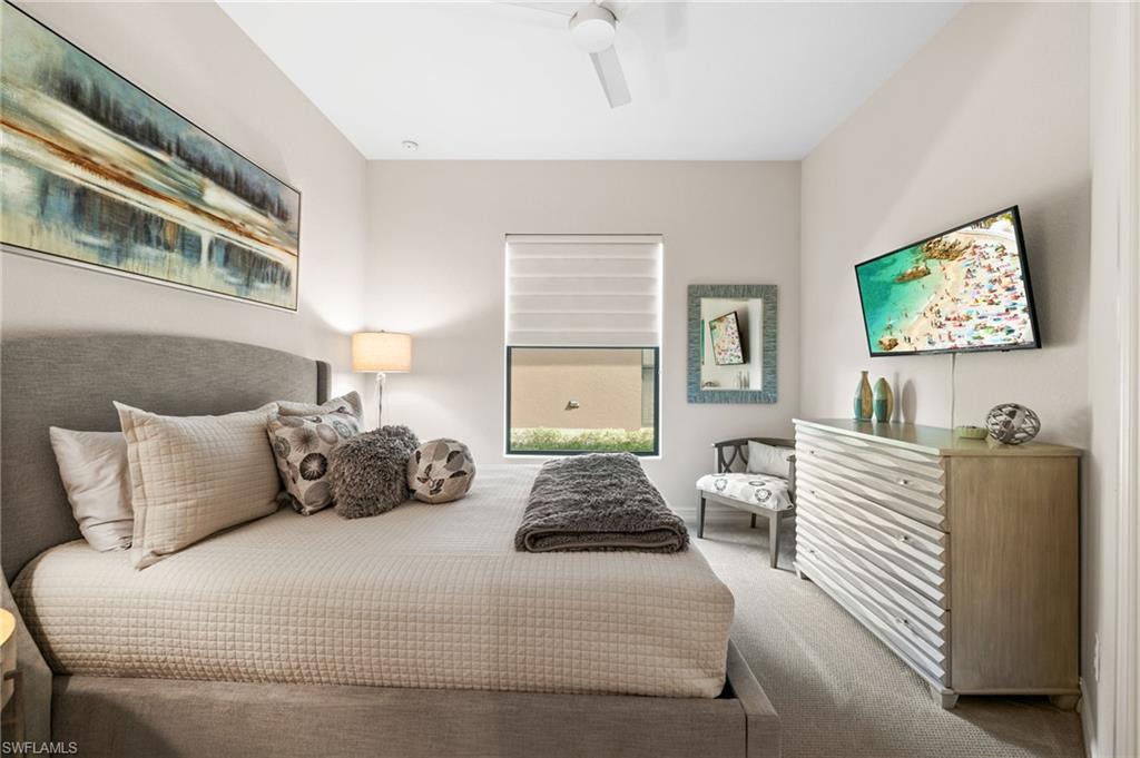 6608 Roma Way Naples, FL 34113 - Photo 22 of 50 Bedroom with ceiling fan and carpet flooring