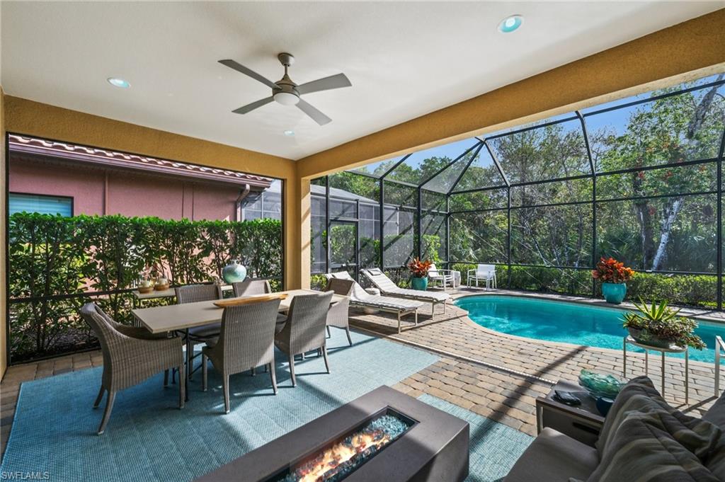 6608 Roma Way Naples, FL 34113 - Photo 28 of 50 View of swimming pool featuring a lanai, an outdoor fire pit, and a patio