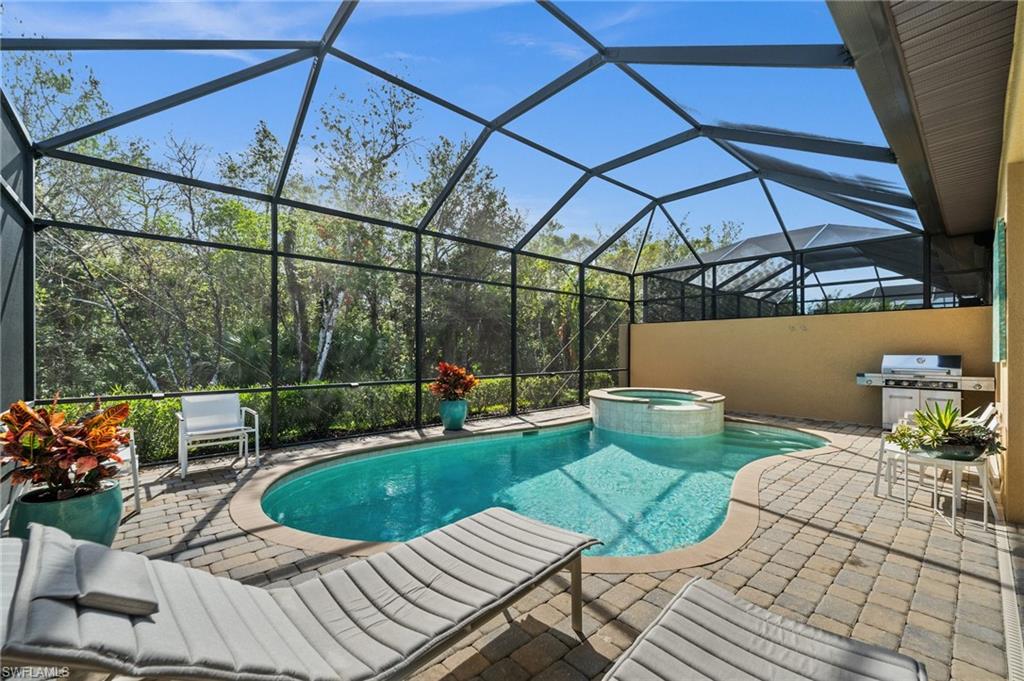 6608 Roma Way Naples, FL 34113 - Photo 29 of 50 View of swimming pool with an in ground hot tub, a lanai, a grill, and a patio area