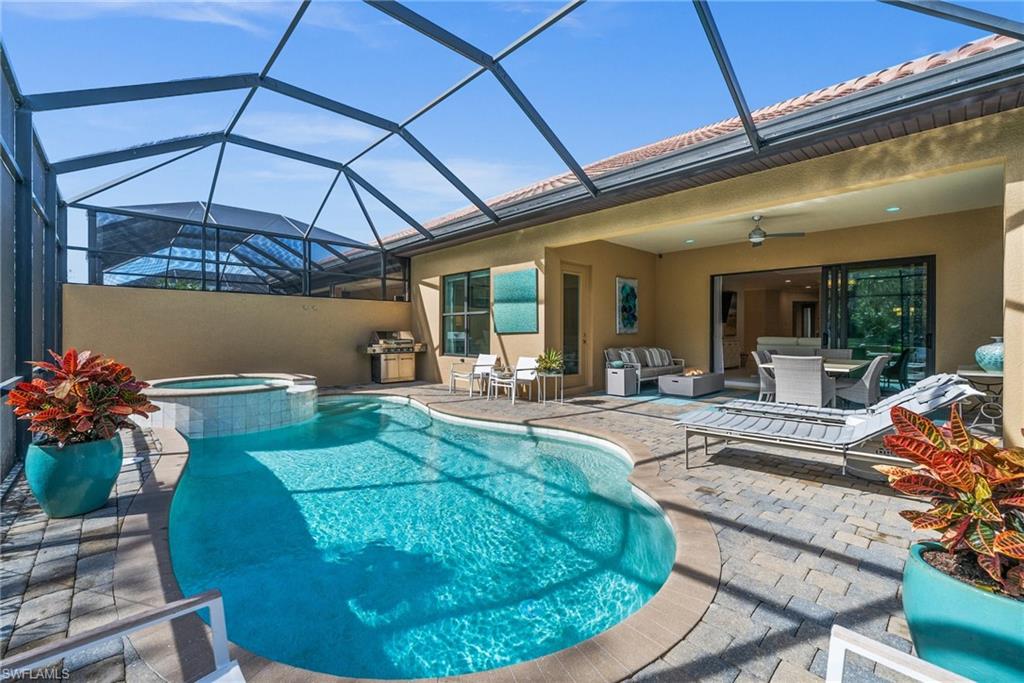 6608 Roma Way Naples, FL 34113 - Photo 30 of 50 View of swimming pool with a lanai, an outdoor hangout area, a patio, and an in ground hot tub
