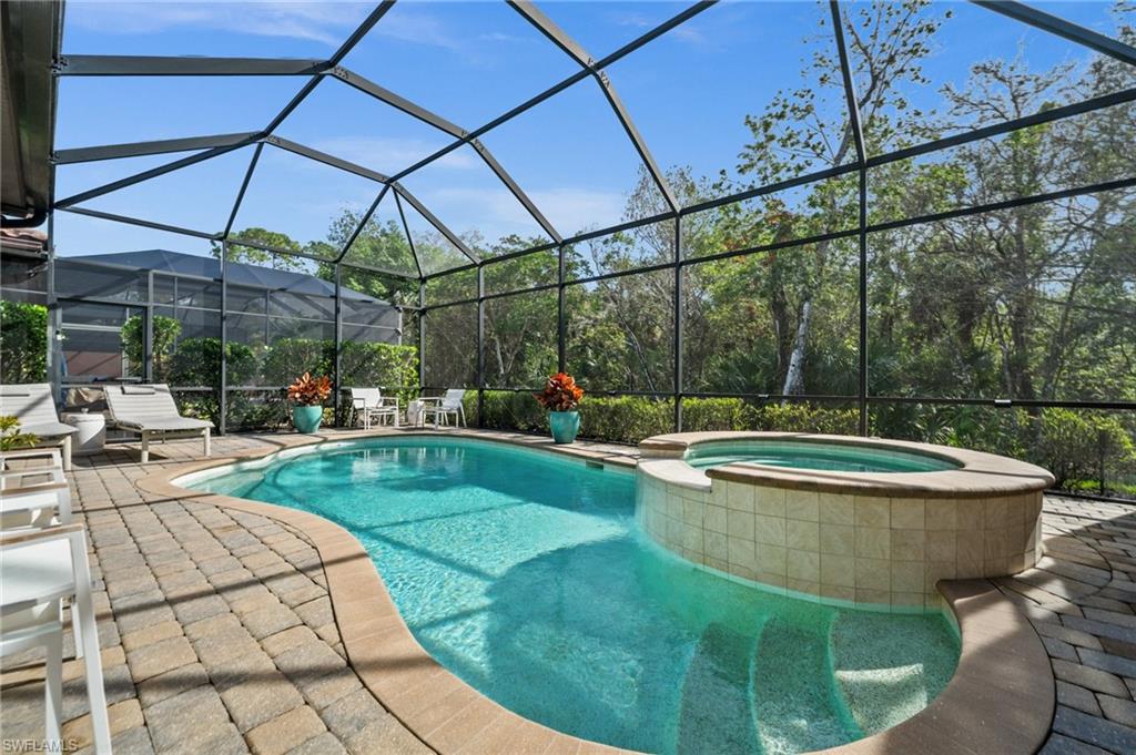 6608 Roma Way Naples, FL 34113 - Photo 31 of 50 View of pool featuring an in ground hot tub, a patio area, and glass enclosure