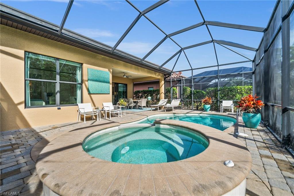 6608 Roma Way Naples, FL 34113 - Photo 32 of 50 View of pool featuring a lanai, a mountain view, ceiling fan, an in ground hot tub, and a patio