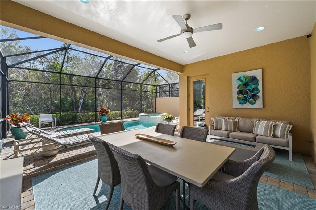 6608 Roma Way Naples, FL 34113 - Photo 33 of 50 View of patio / terrace featuring a lanai, an outdoor hangout area, and a swimming pool with hot tub
