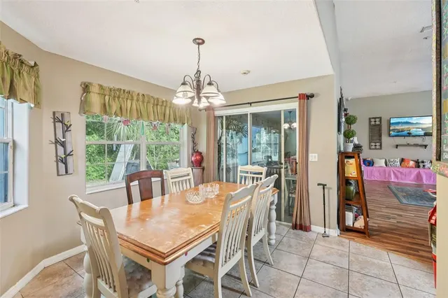 a view of a dining room with furniture large windows and wooden floor