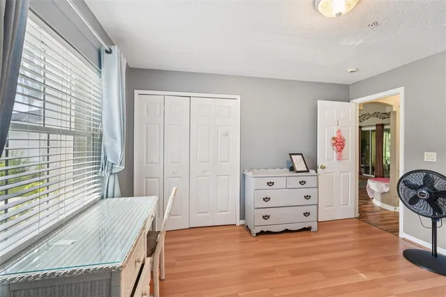 a view of a bedroom with furniture and window
