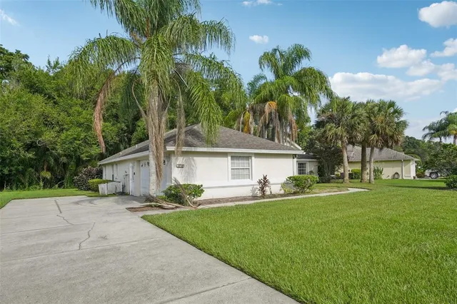 a front view of house with yard and green space