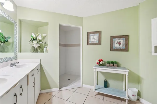 a dining room with glass top table and chairs