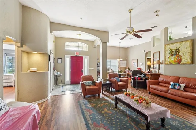 a living room with furniture a rug and a chandelier