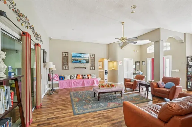 a bedroom with furniture and wooden floor