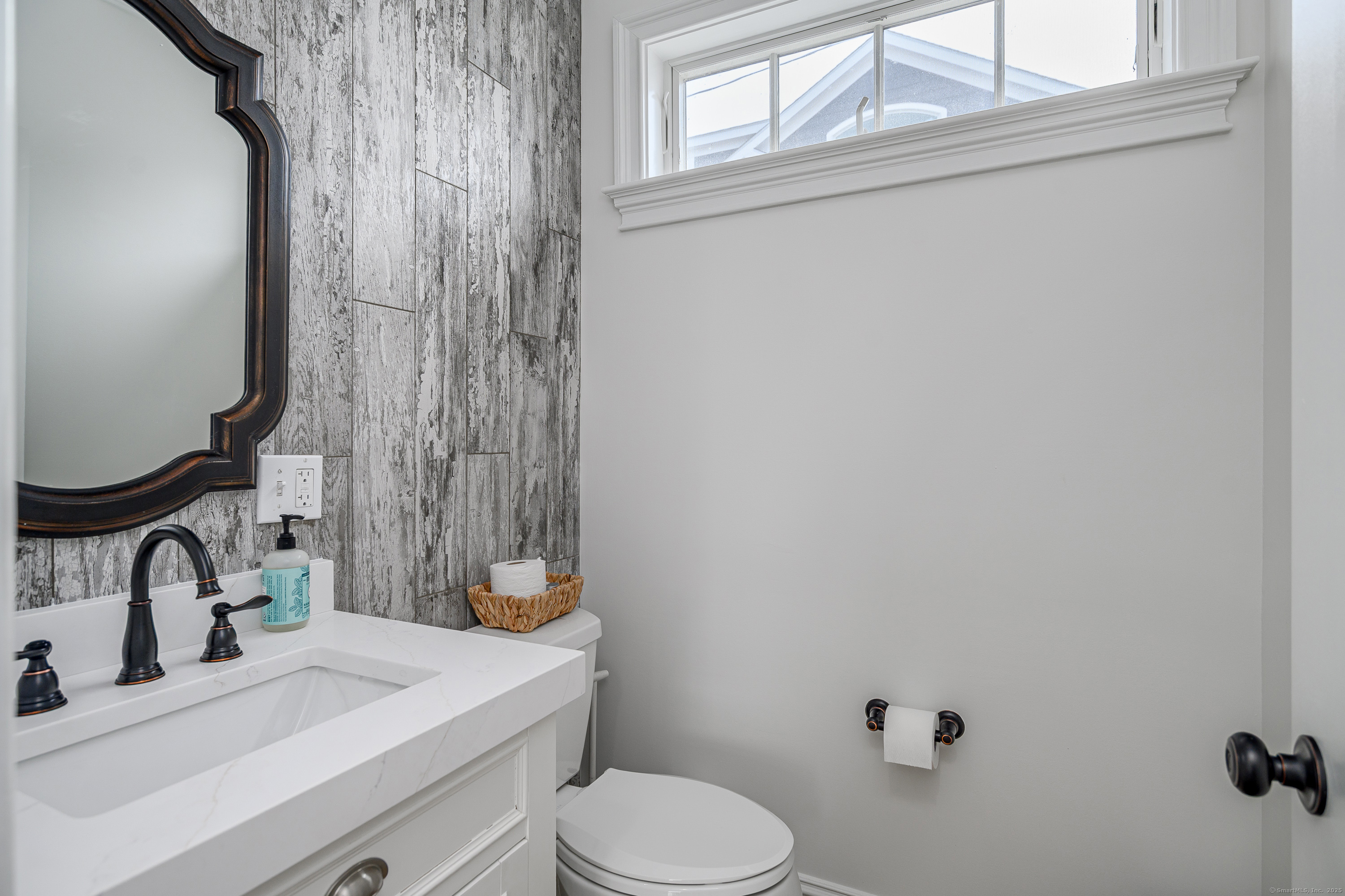2154 Fairfield Beach Road Fairfield, CT 06824 - Photo 17 of 39 a bathroom with a sink toilet and a mirror