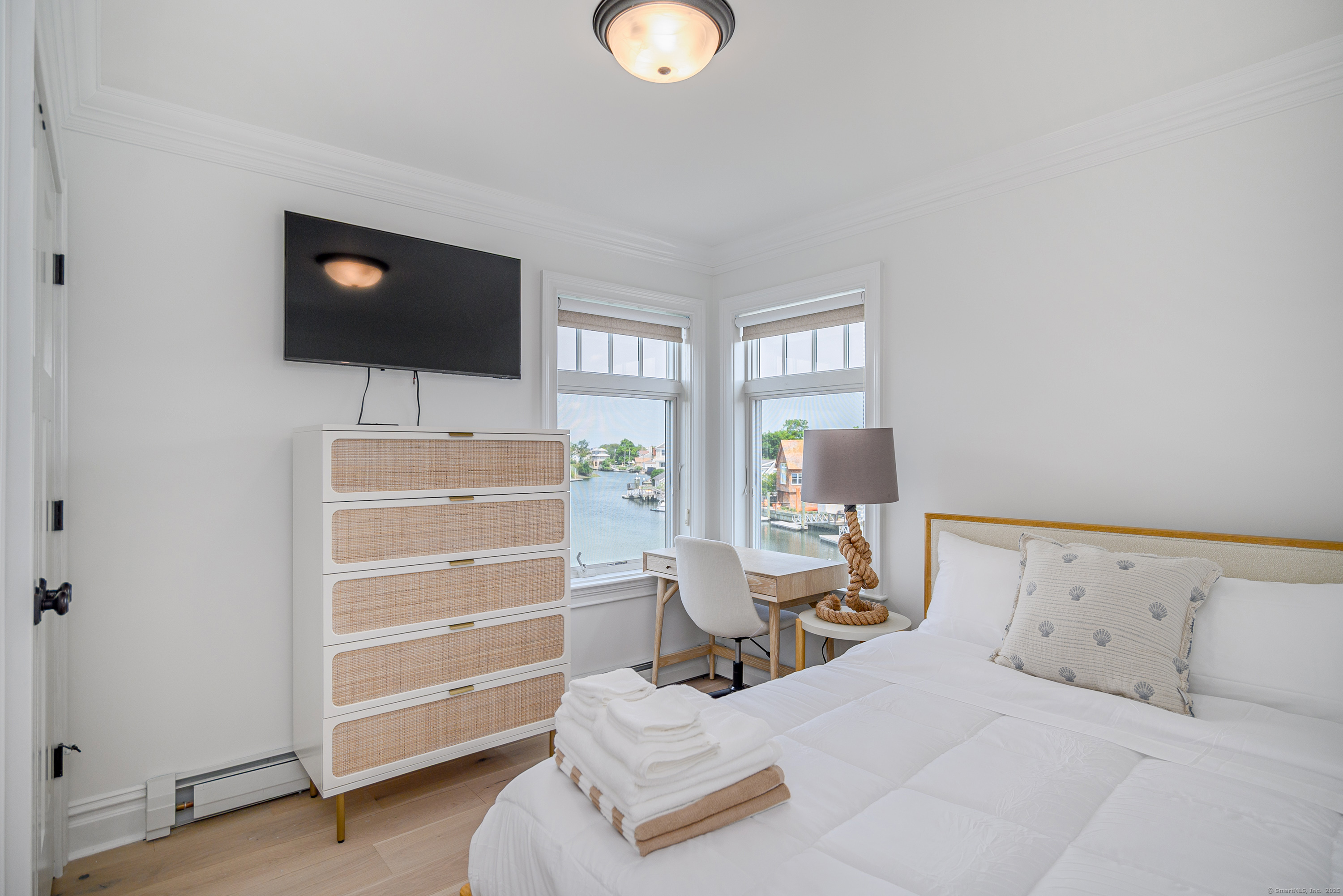 2154 Fairfield Beach Road Fairfield, CT 06824 - Photo 18 of 39 a bedroom with a bed and a flat screen tv