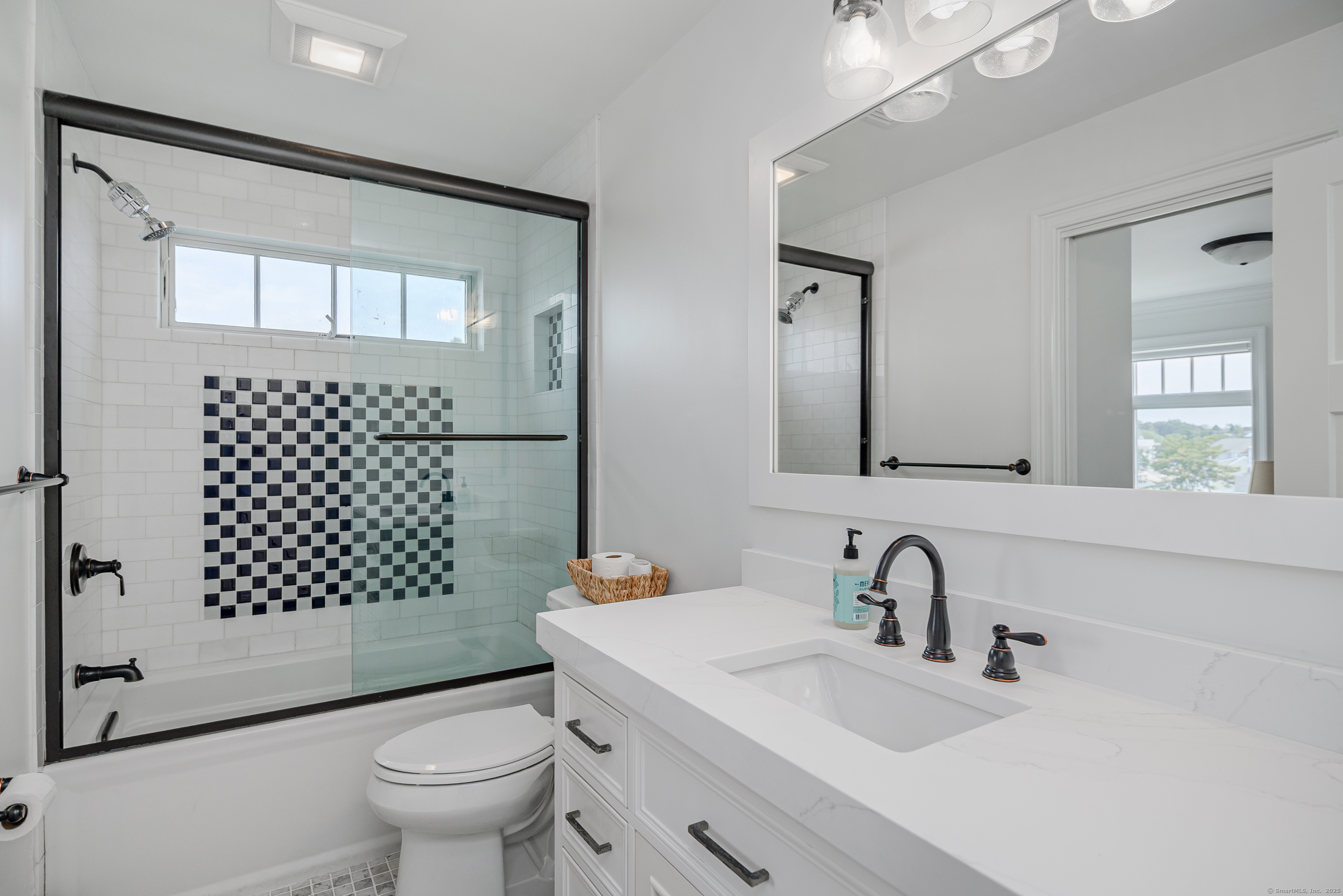 2154 Fairfield Beach Road Fairfield, CT 06824 - Photo 20 of 39 a bathroom with a sink toilet mirror and shower