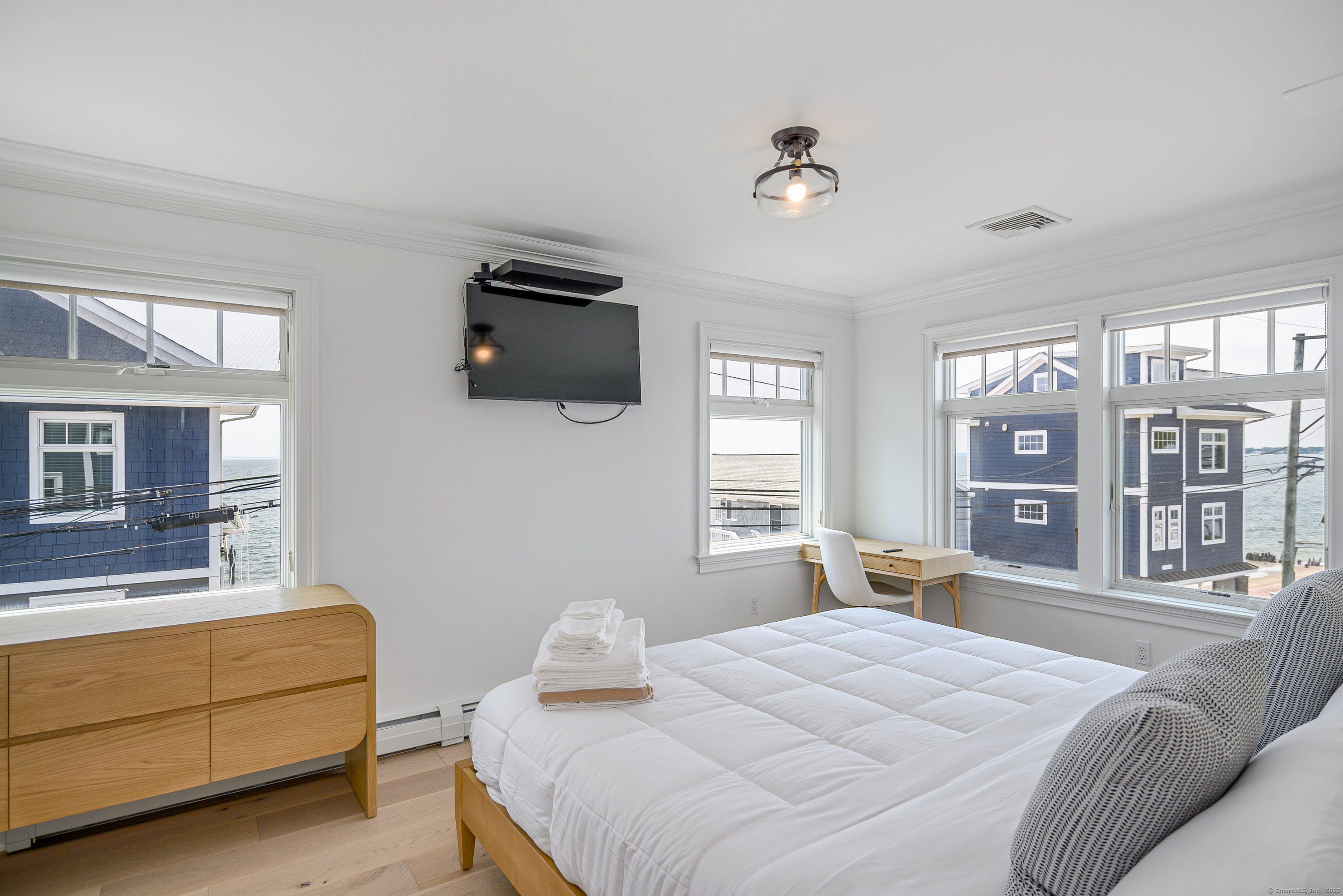 2154 Fairfield Beach Road Fairfield, CT 06824 - Photo 21 of 39 a bedroom with a bed and wooden floor