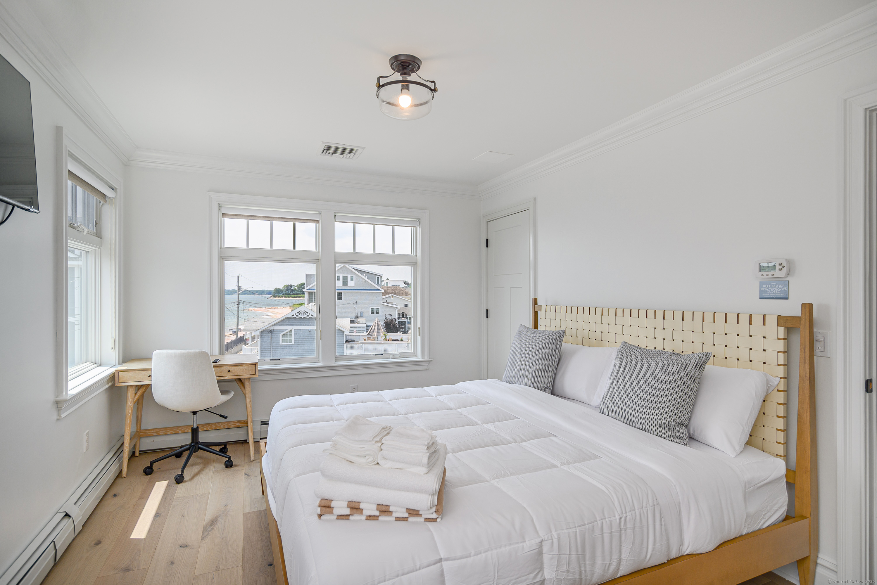 2154 Fairfield Beach Road Fairfield, CT 06824 - Photo 22 of 39 a bedroom with a bed and a window