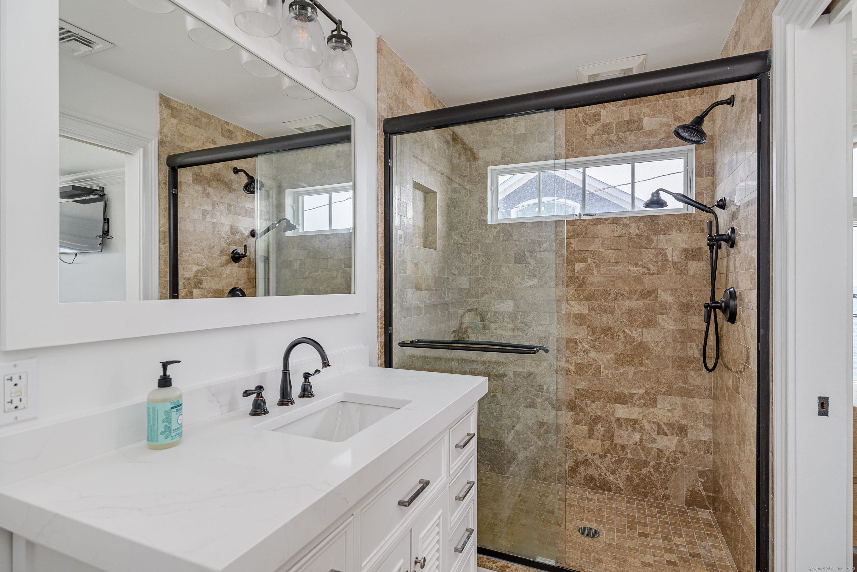 2154 Fairfield Beach Road Fairfield, CT 06824 - Photo 23 of 39 a bathroom with a sink and a mirror