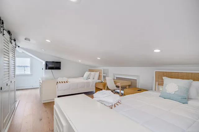 a bedroom with furniture and a flat screen tv