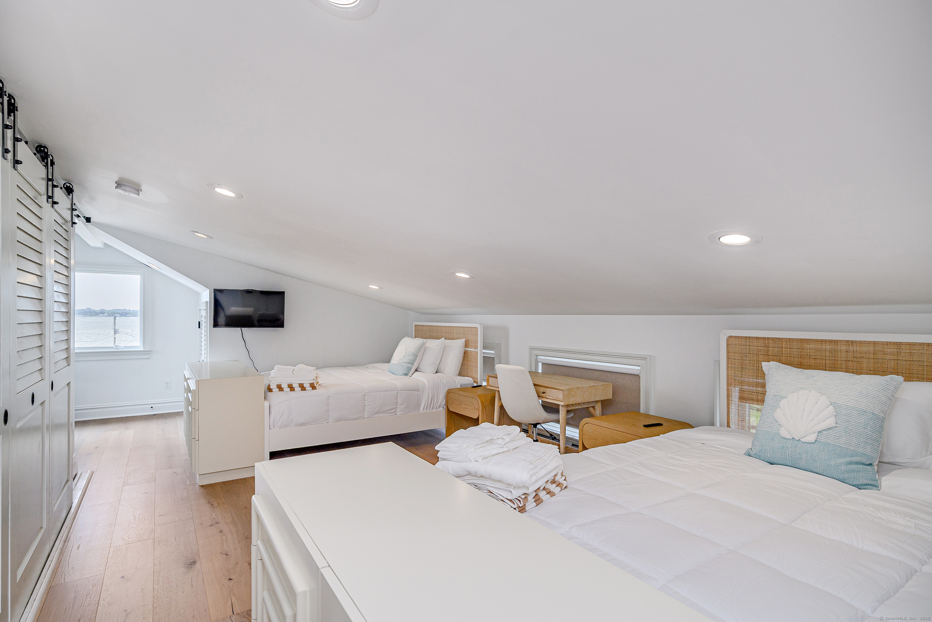 2154 Fairfield Beach Road Fairfield, CT 06824 - Photo 25 of 39 a bedroom with a large bed and a couch