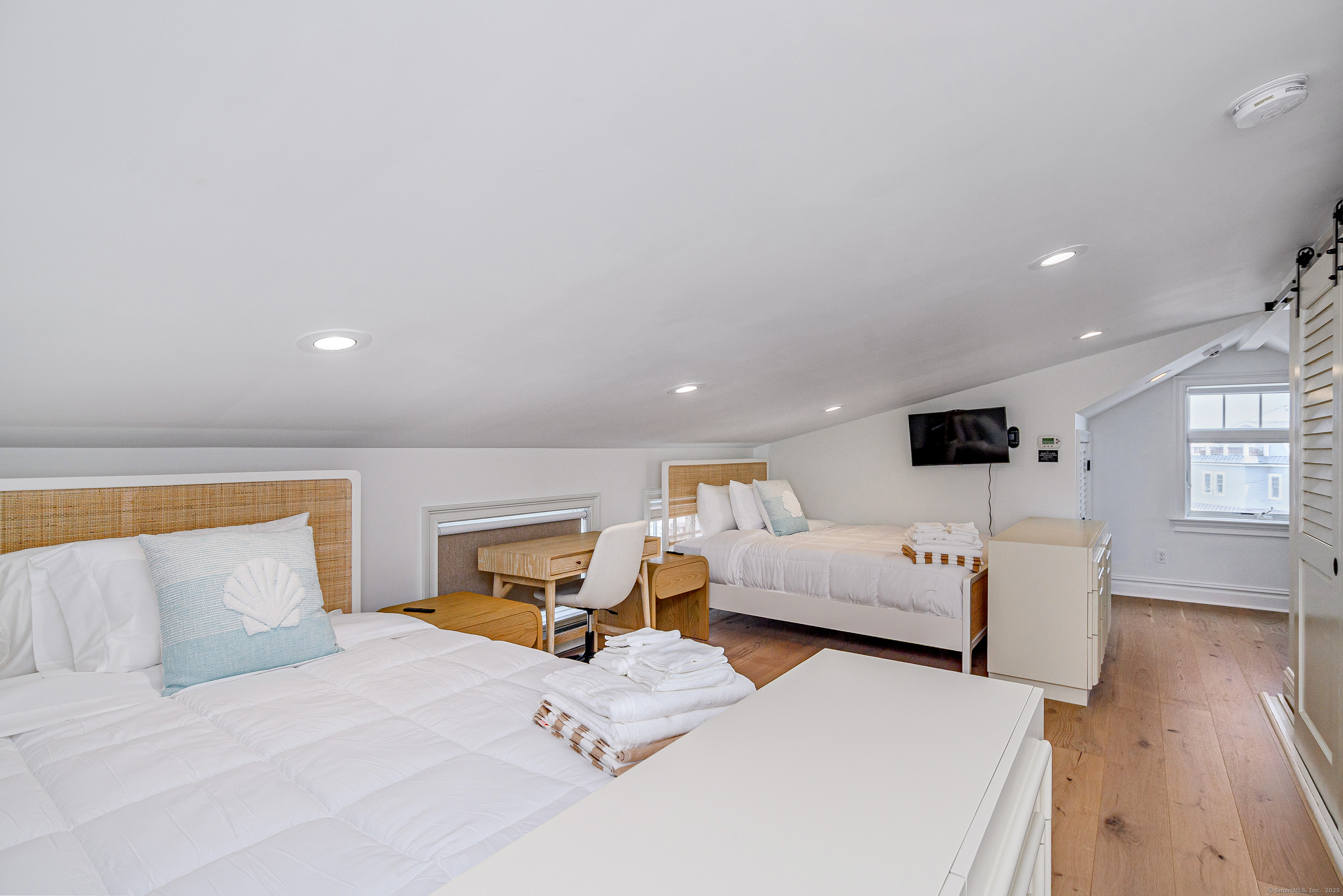 2154 Fairfield Beach Road Fairfield, CT 06824 - Photo 26 of 39 a bedroom with furniture and a flat screen tv