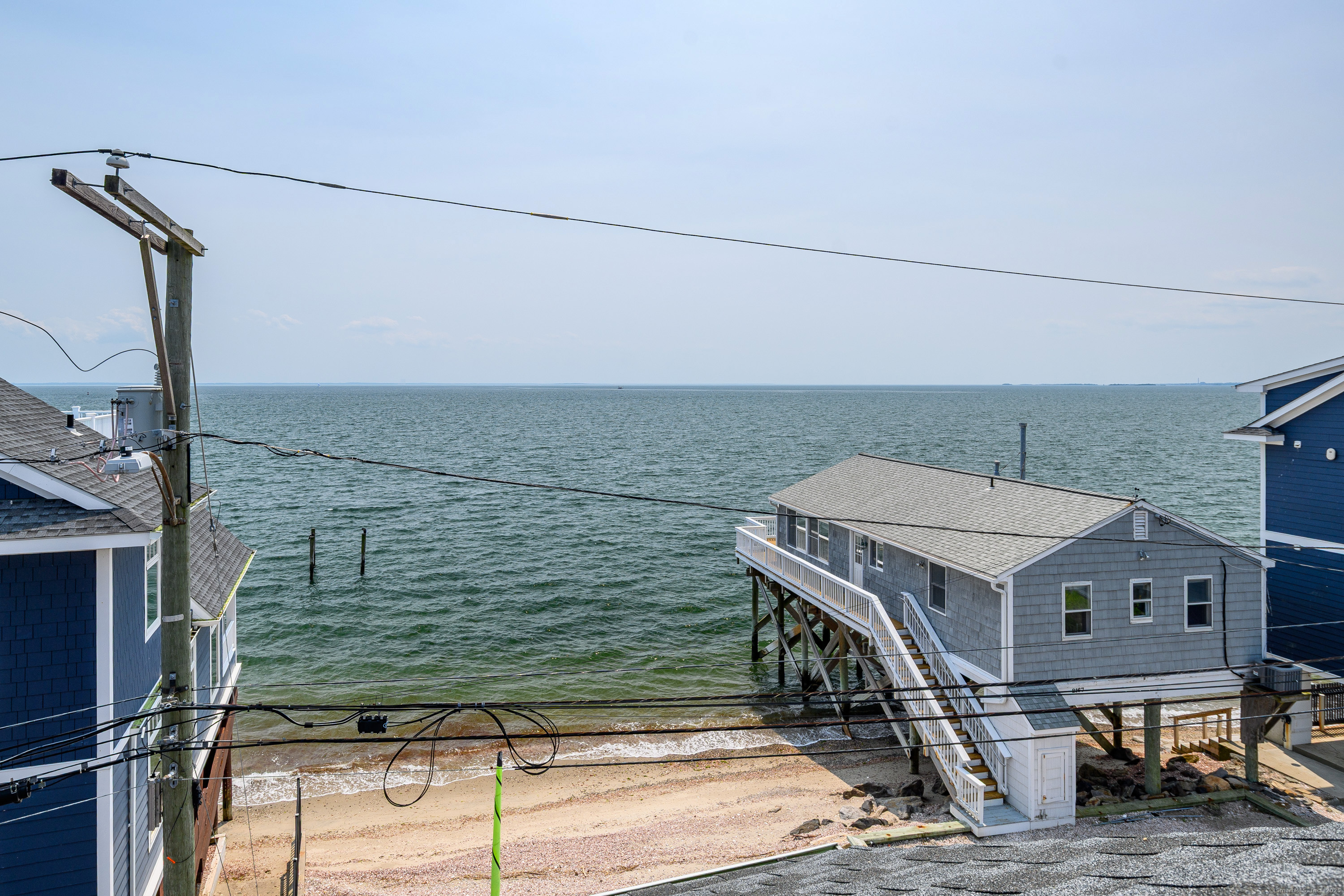 2154 Fairfield Beach Road Fairfield, CT 06824 - Photo 28 of 39 a roof deck with table and chairs