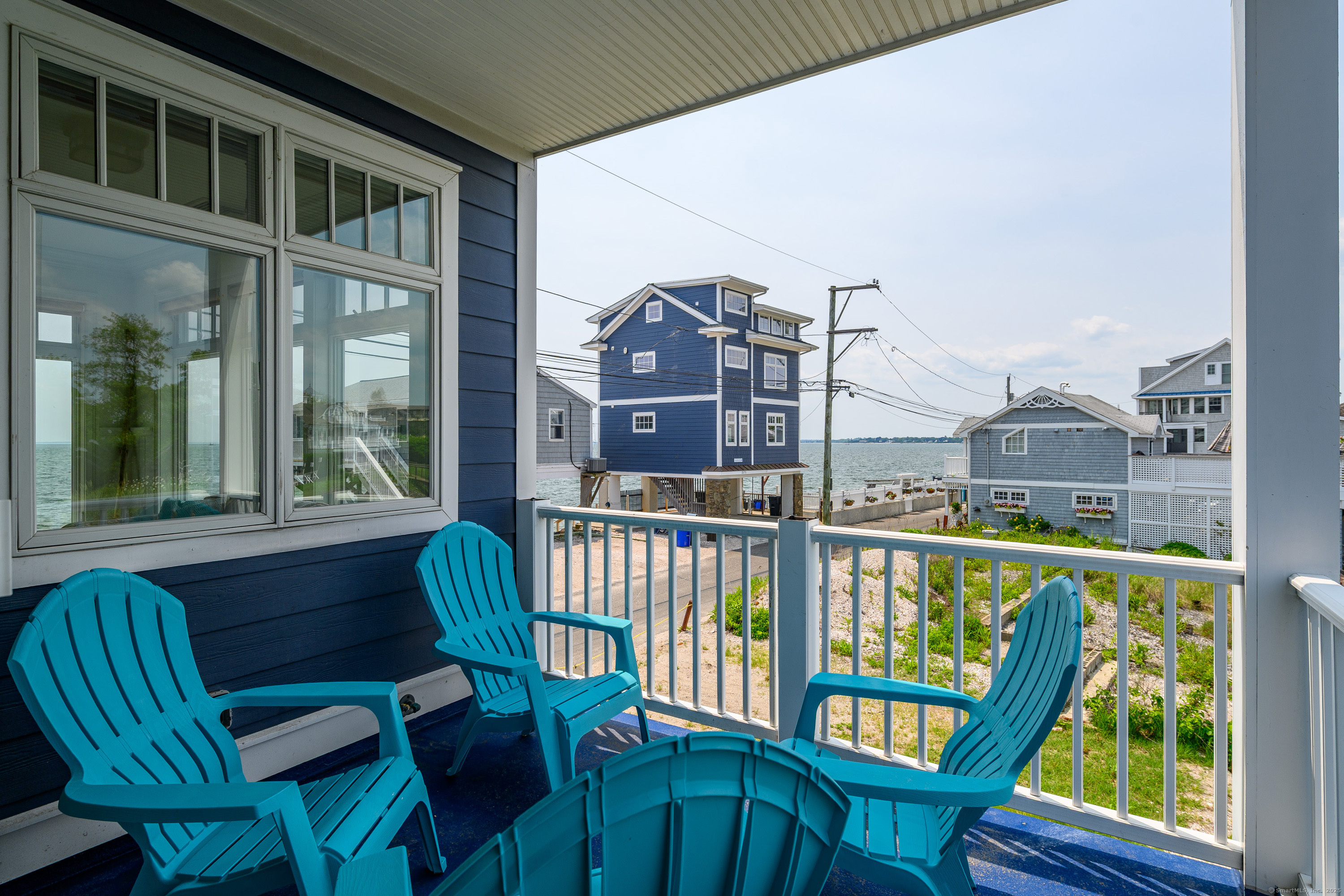 2154 Fairfield Beach Road Fairfield, CT 06824 - Photo 34 of 39 a view of a chairs and table in the balcony