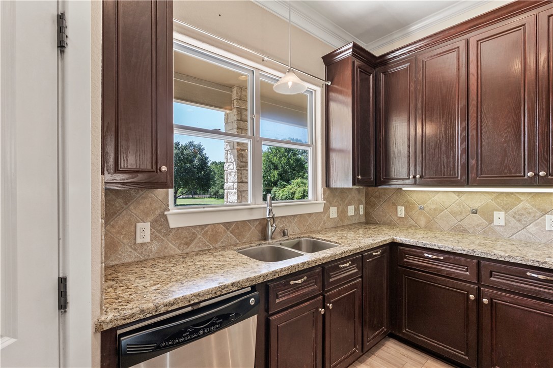 6701 Old Reliance Road Bryan, TX 77808 - Photo 10 of 44 a kitchen with granite countertop a sink and a window