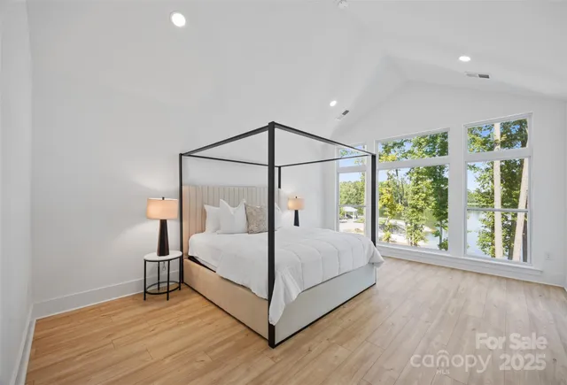 a bedroom with a bed and a large window