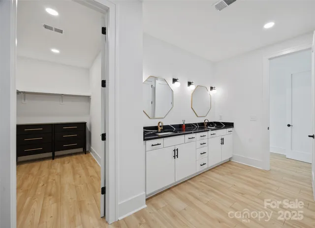a kitchen with granite countertop white cabinets and a stove