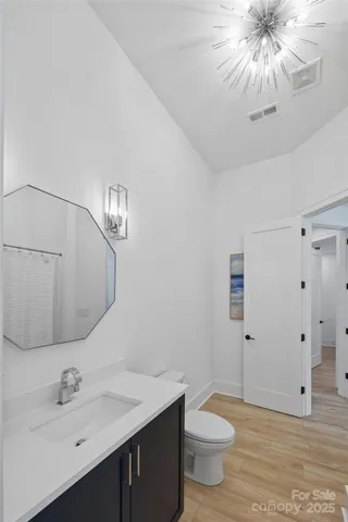 a bathroom with a sink a toilet and a mirror