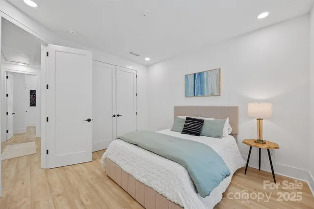 a bedroom with a bed and a night stand