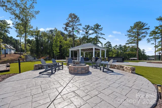 a view of swimming pool with outdoor seating and plants