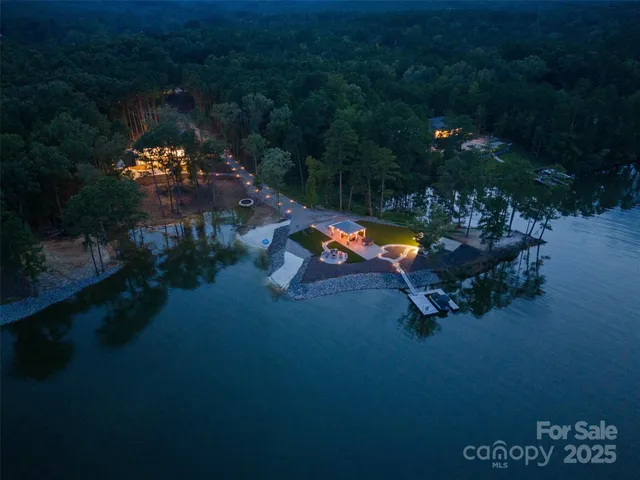 an outdoor space with swimming pool fire pit and outdoor seating