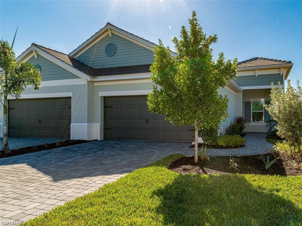 a front view of a house with a yard and garage