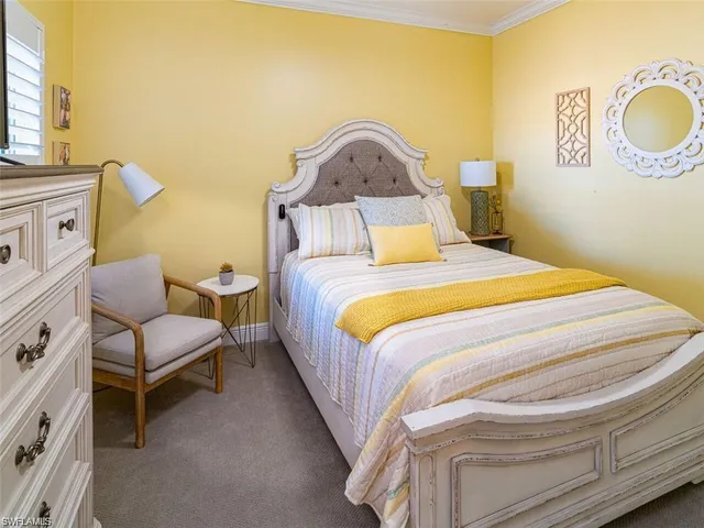 a bedroom with a bed chair and a window