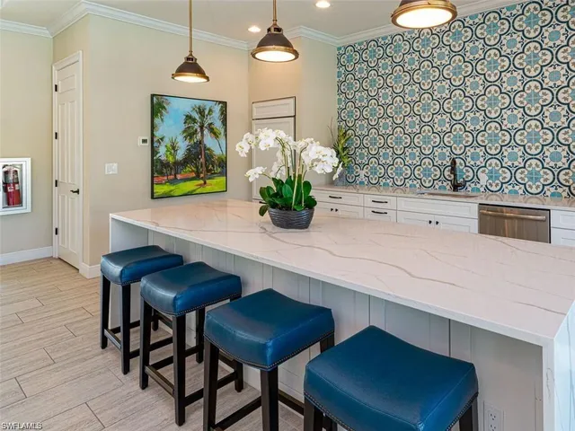 a kitchen with a table chairs and chandelier