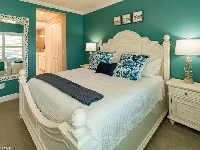 a bedroom with a bed and a lamp