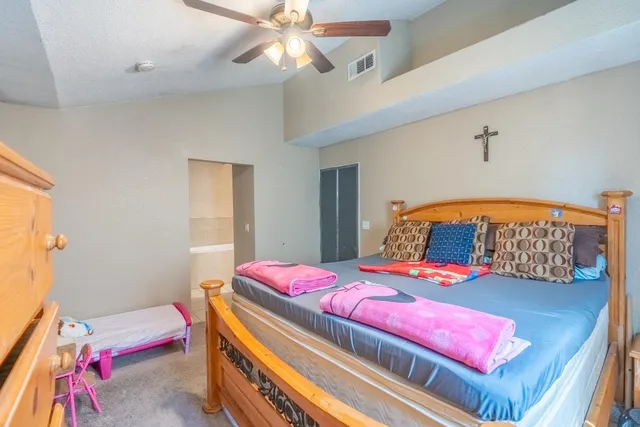 a bedroom with bed and a window