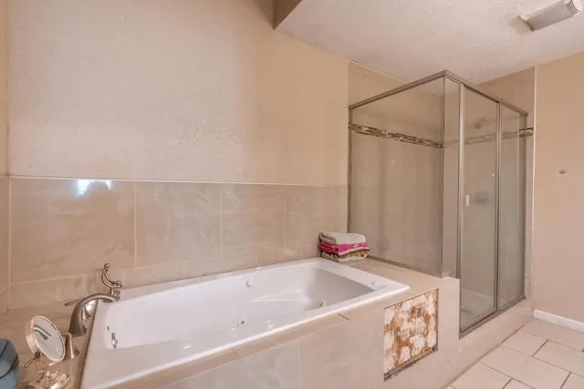 a bathroom with a tub and shower